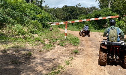 Two persons riding quad bikes on a trail
